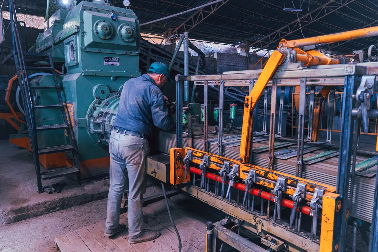 A factory worker operating industrial machinery